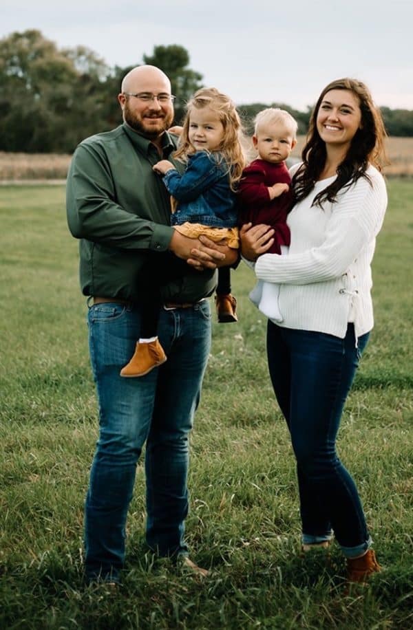 Derek and Taylor Schmitz with children Olivia and Wren at their farm near Cold Spring, Minnesota.