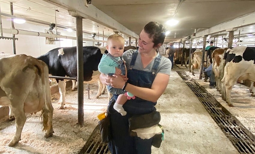 Seen here in the milking parlor is Taylor and baby Wren. Derek says regenerative dairying is family friendly, which is one of its most valuable benefits.